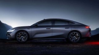 Geely Galaxy TT silver mid-large AI EV fastback sedan front three-quarter view on light backdrop showing rounded-edge tension surface styling