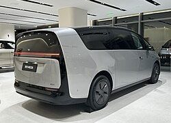 Li Auto Mega MPV silver rear three-quarter in polished indoor showroom highlighting Li Auto's current pure-electric BEV benchmark platform