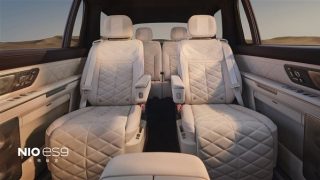 NIO ES9 cream Nappa cabin with diamond-quilted seats front captain-chair armrests and desert horizon out the window