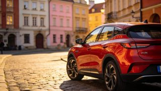 Chinese-brand electric vehicle on a Warsaw old-town cobblestone street