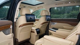 Maextro V800 luxury MPV rear-seat cabin with dual OLED screens and wood trim